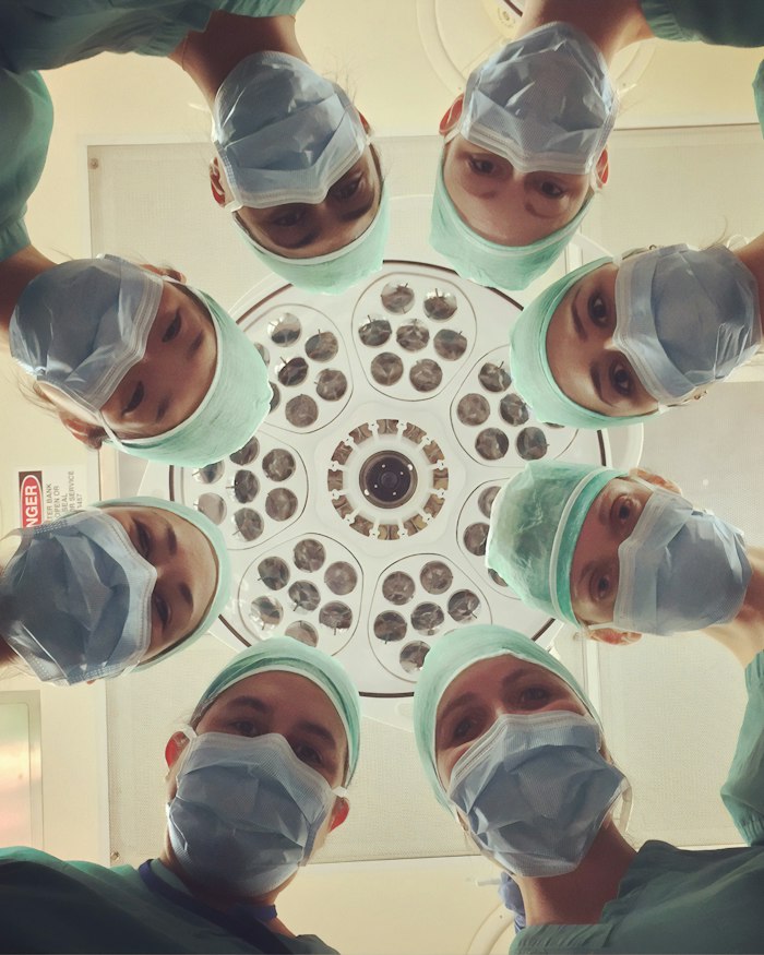 Surgical team at work under operating lights